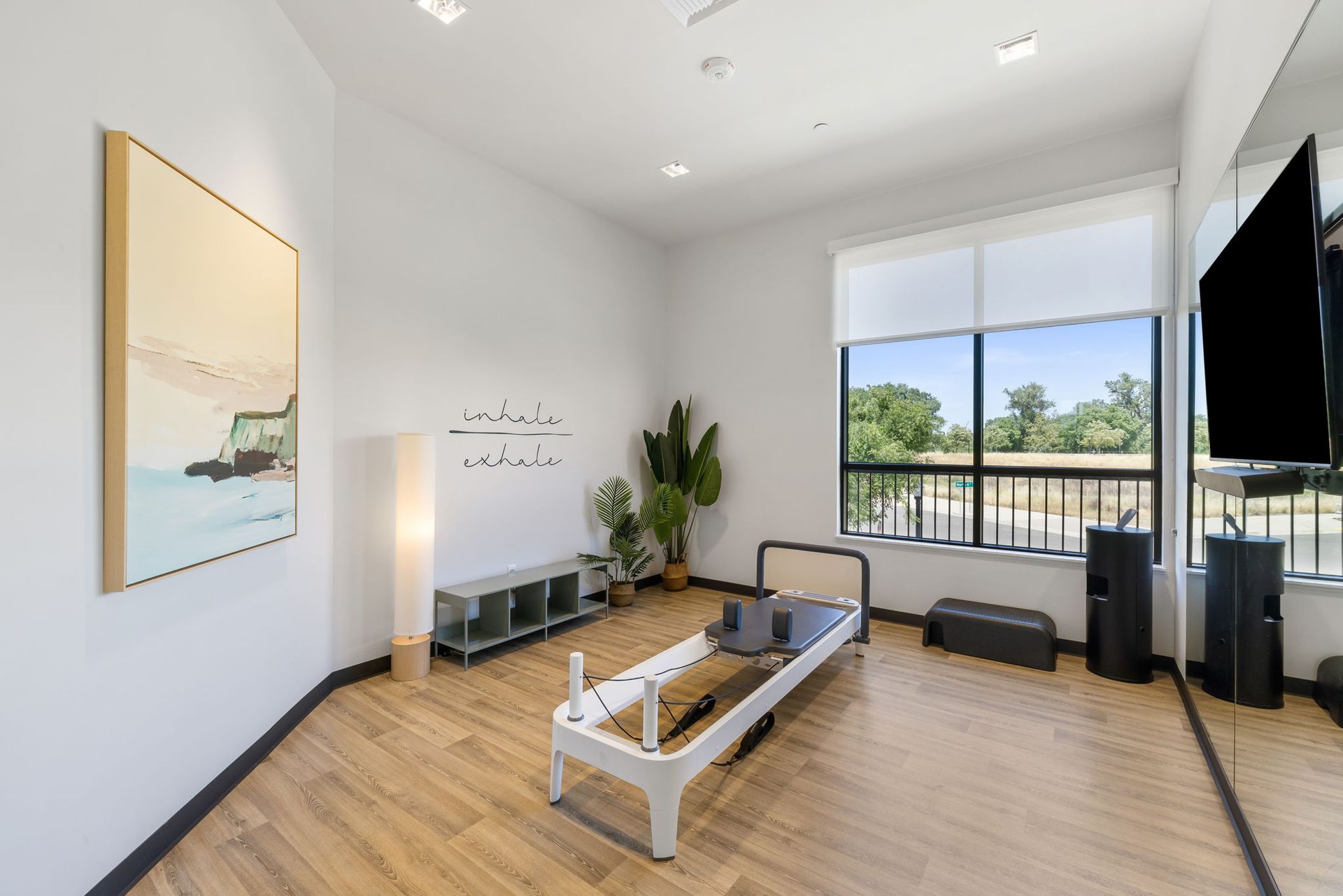 There is a pilates machine in the middle of the room.