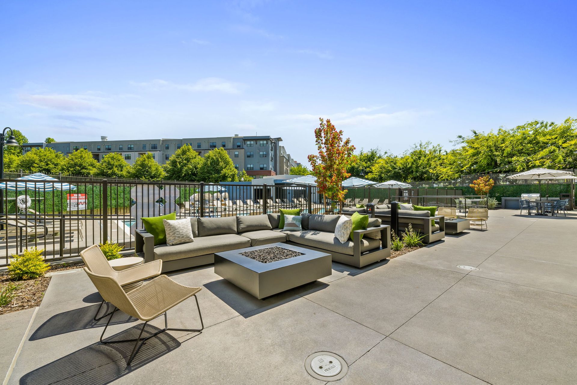 There is a fire pit in the middle of the patio area.