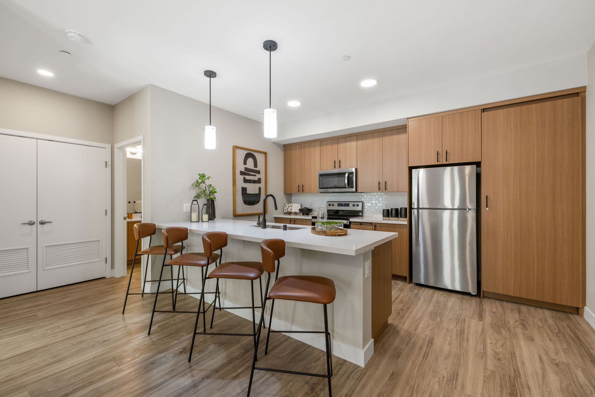 A kitchen with stainless steel appliances and wooden cabinets.