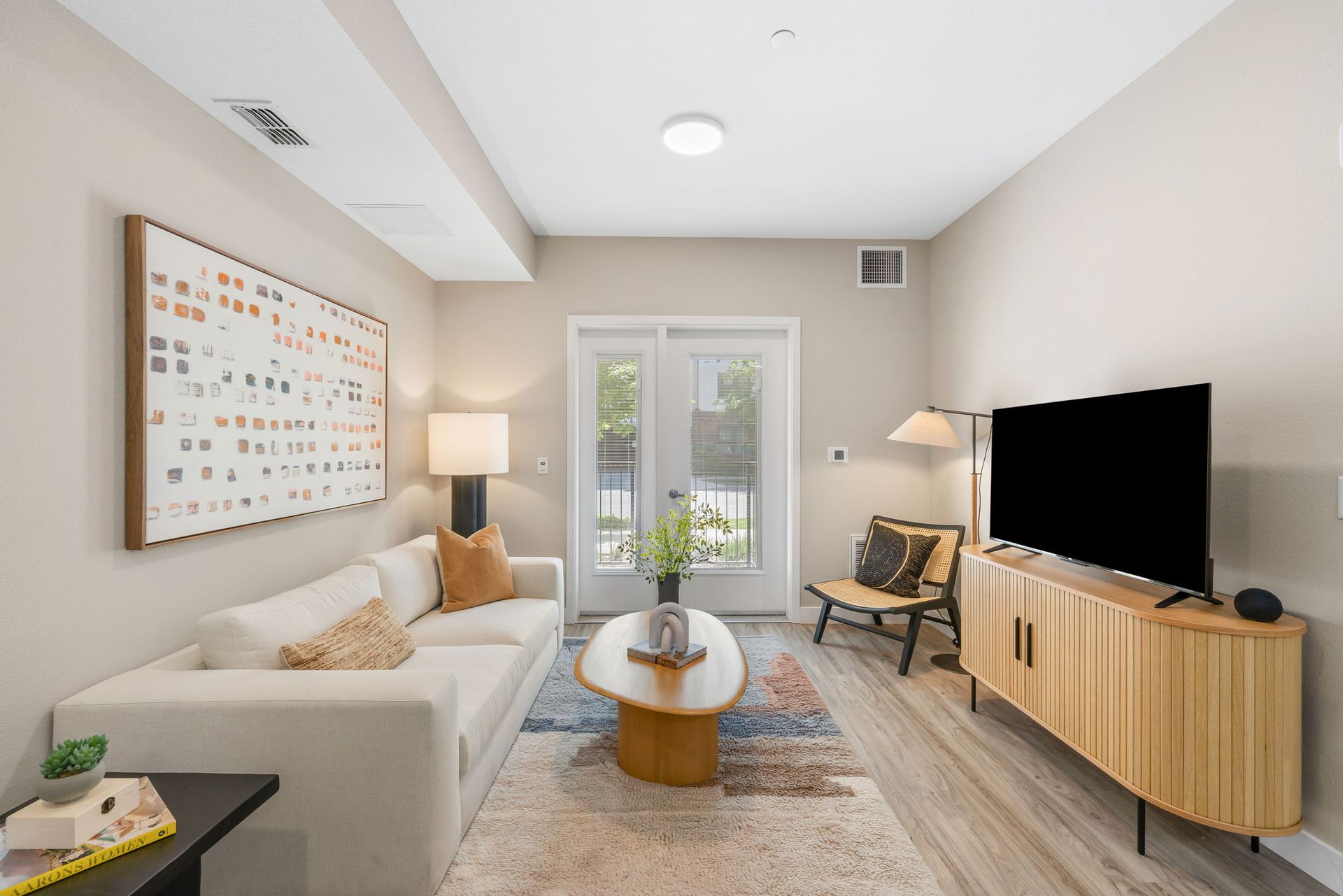A living room with a couch , coffee table , and television.
