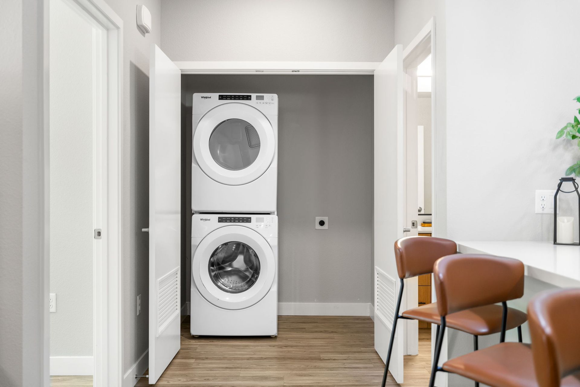 A laundry room with a washer and dryer stacked on top of each other.