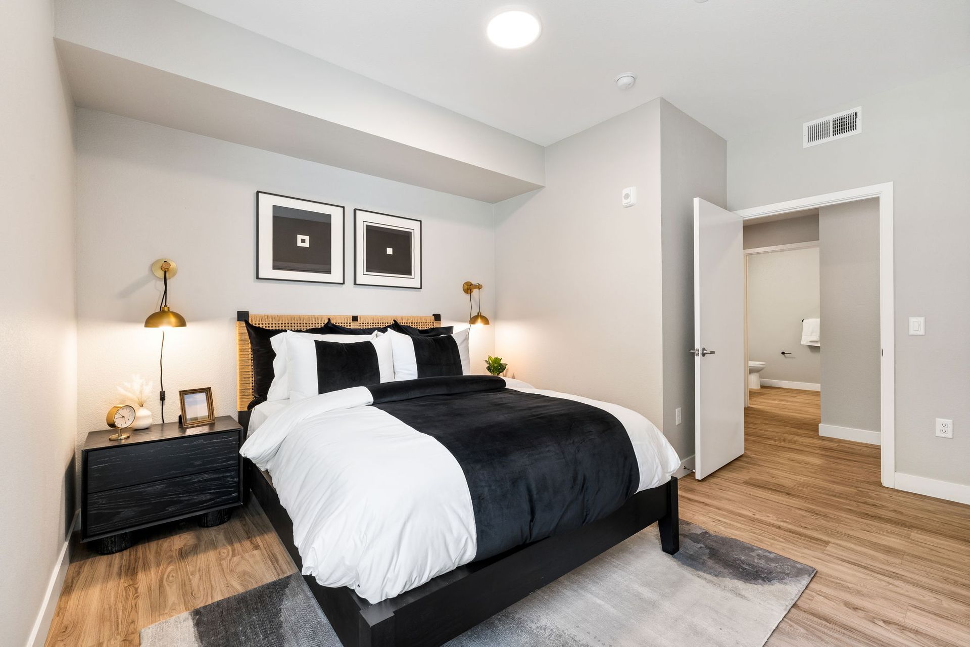 A bedroom with a king size bed , nightstands , and a rug.