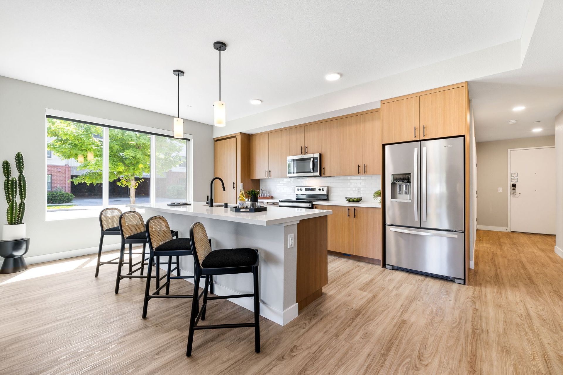 A kitchen with stainless steel appliances , wooden cabinets , and a large island.