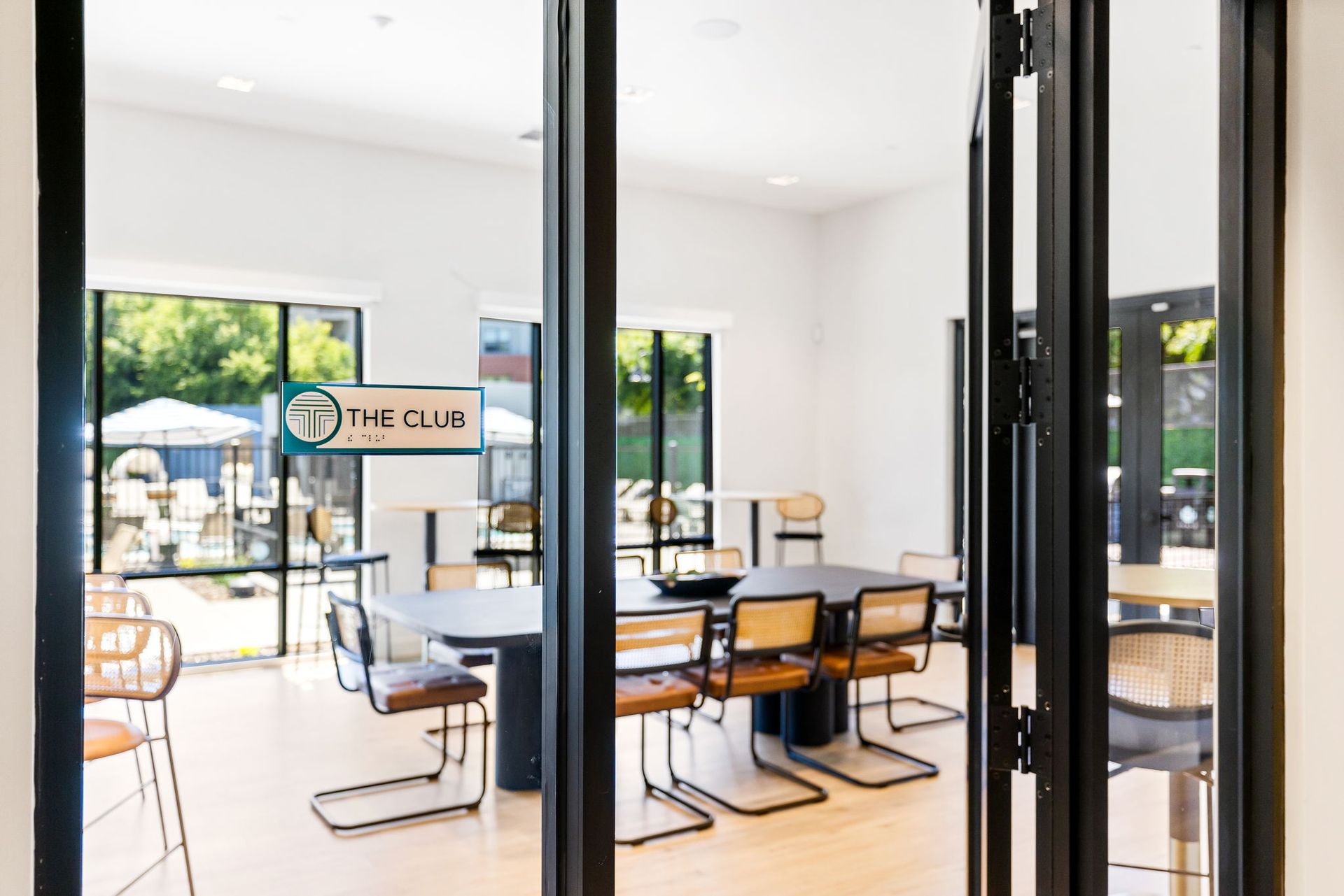 A room with tables and chairs and a sign that says the club.