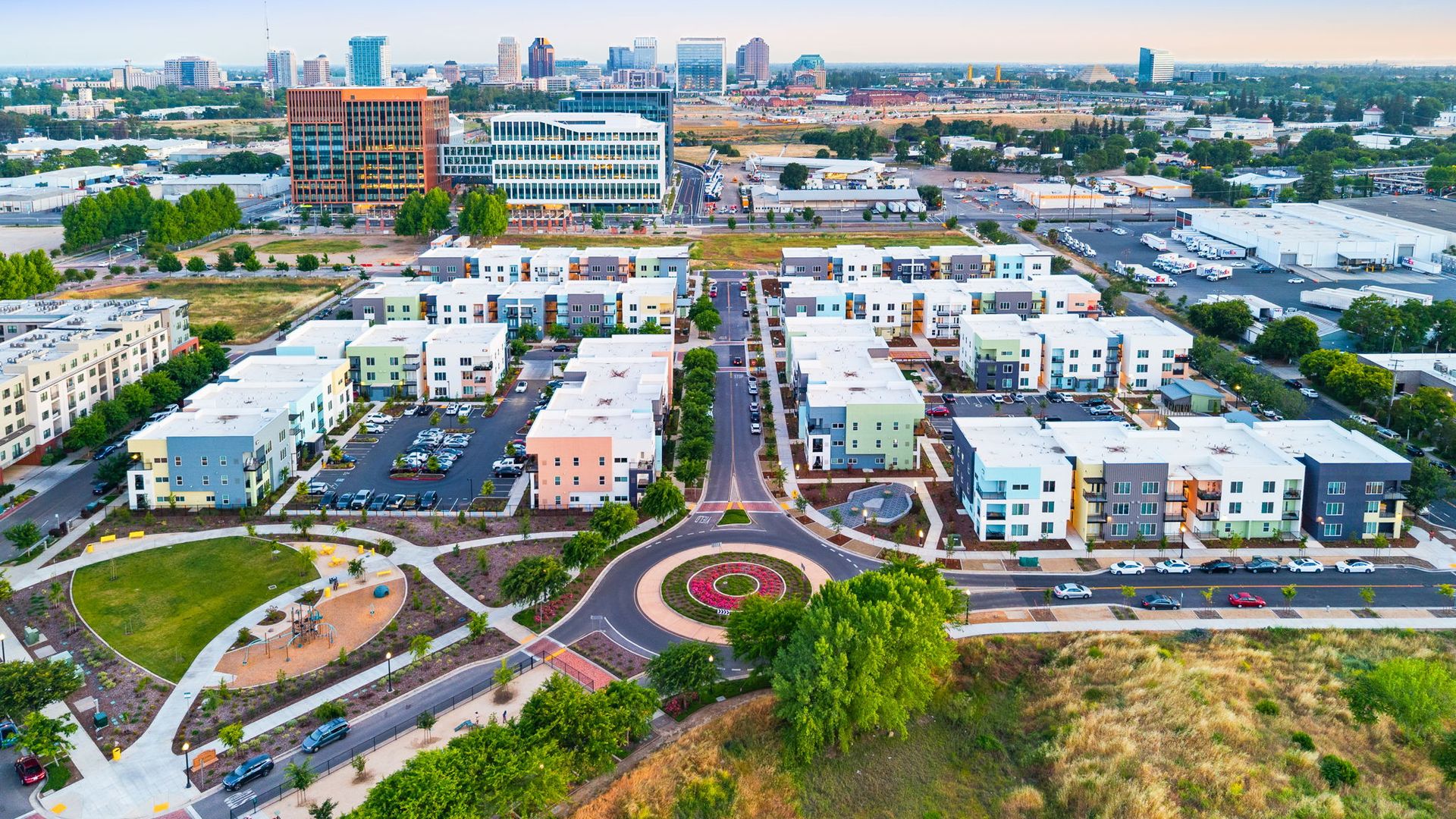 An aerial view of a residential area with a city in the background.