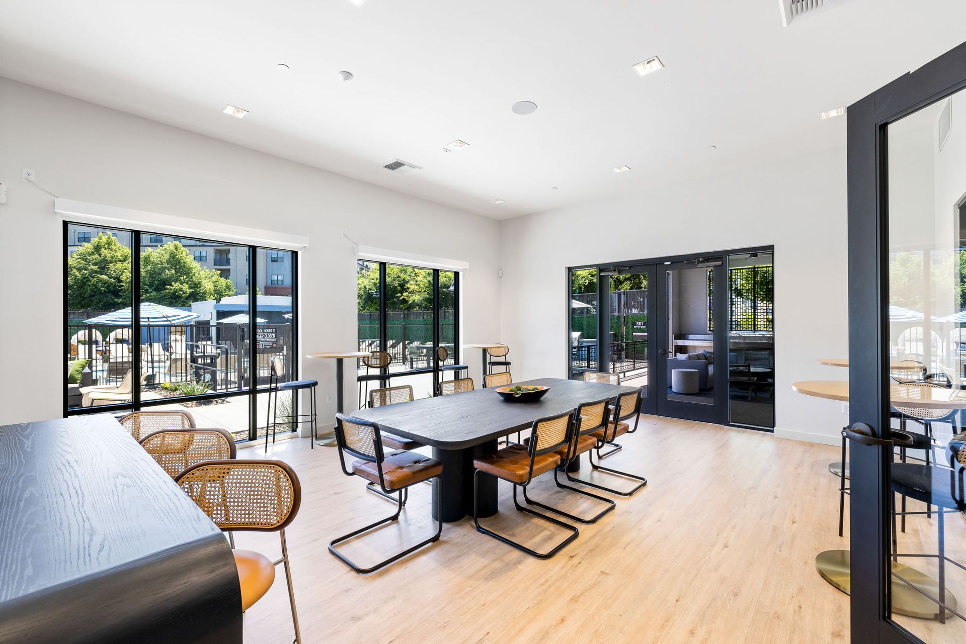 A large room with a table and chairs in it.