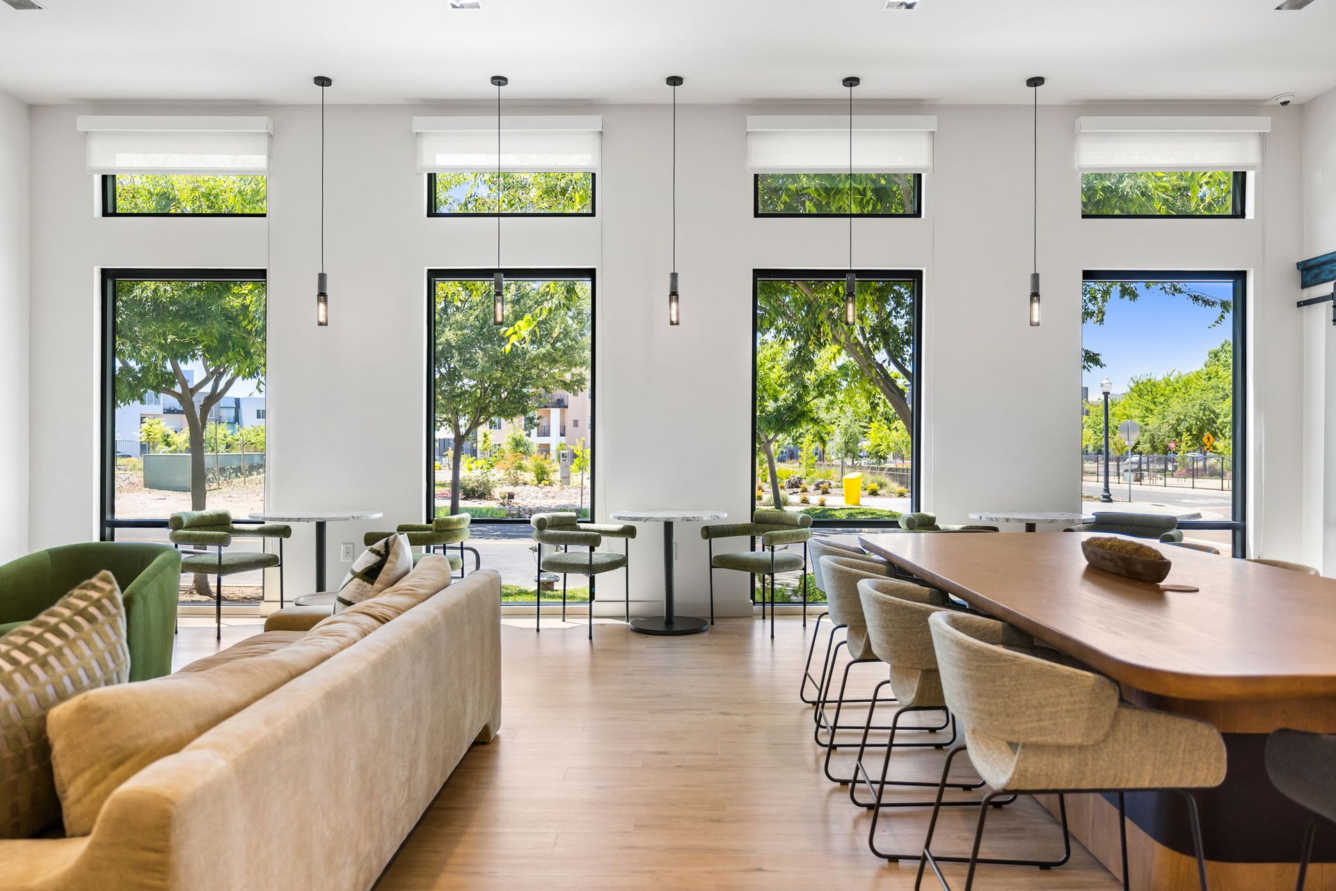 Clubhouse with a couch , table , chairs and windows.