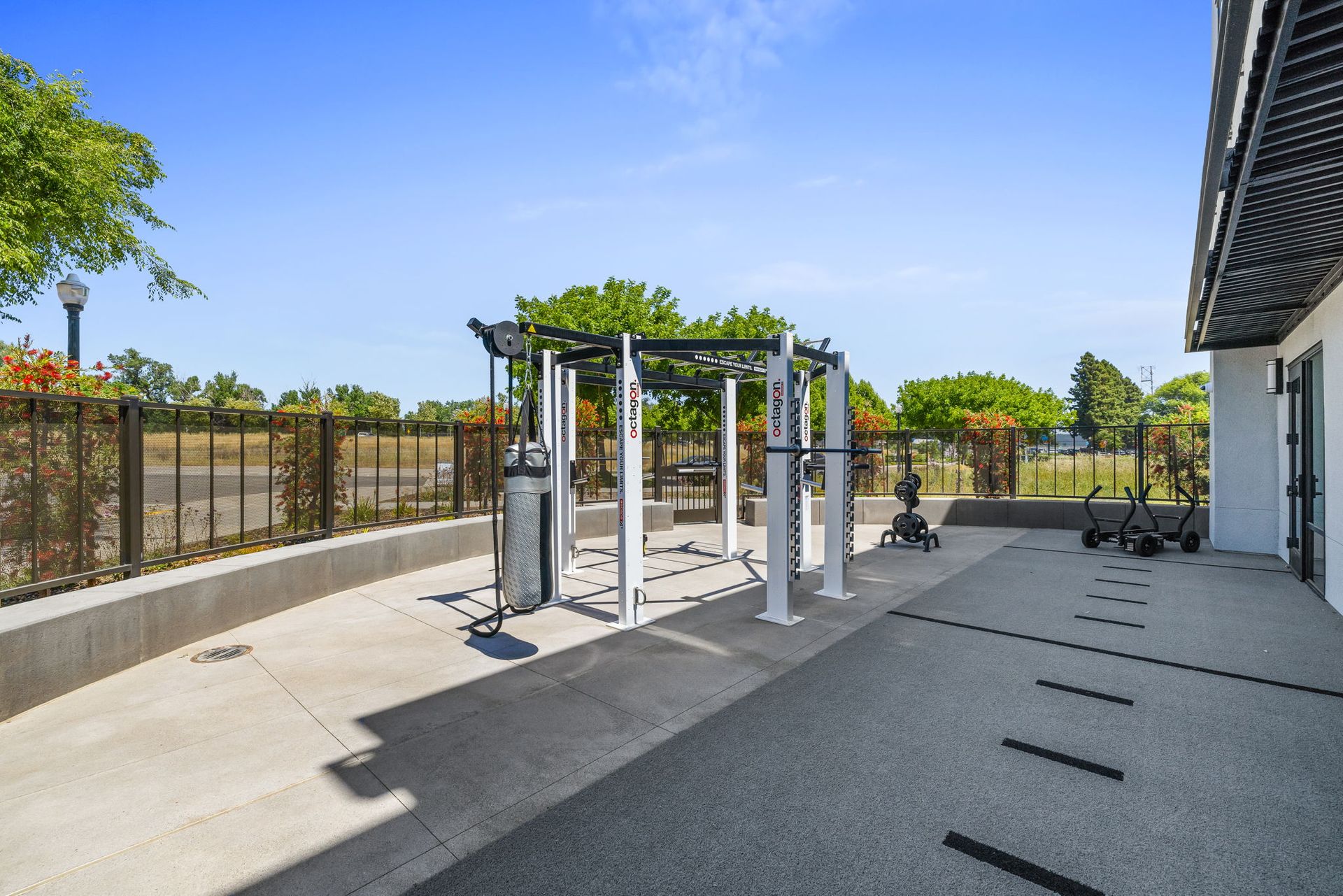 A gym with a lot of equipment outside of a building.