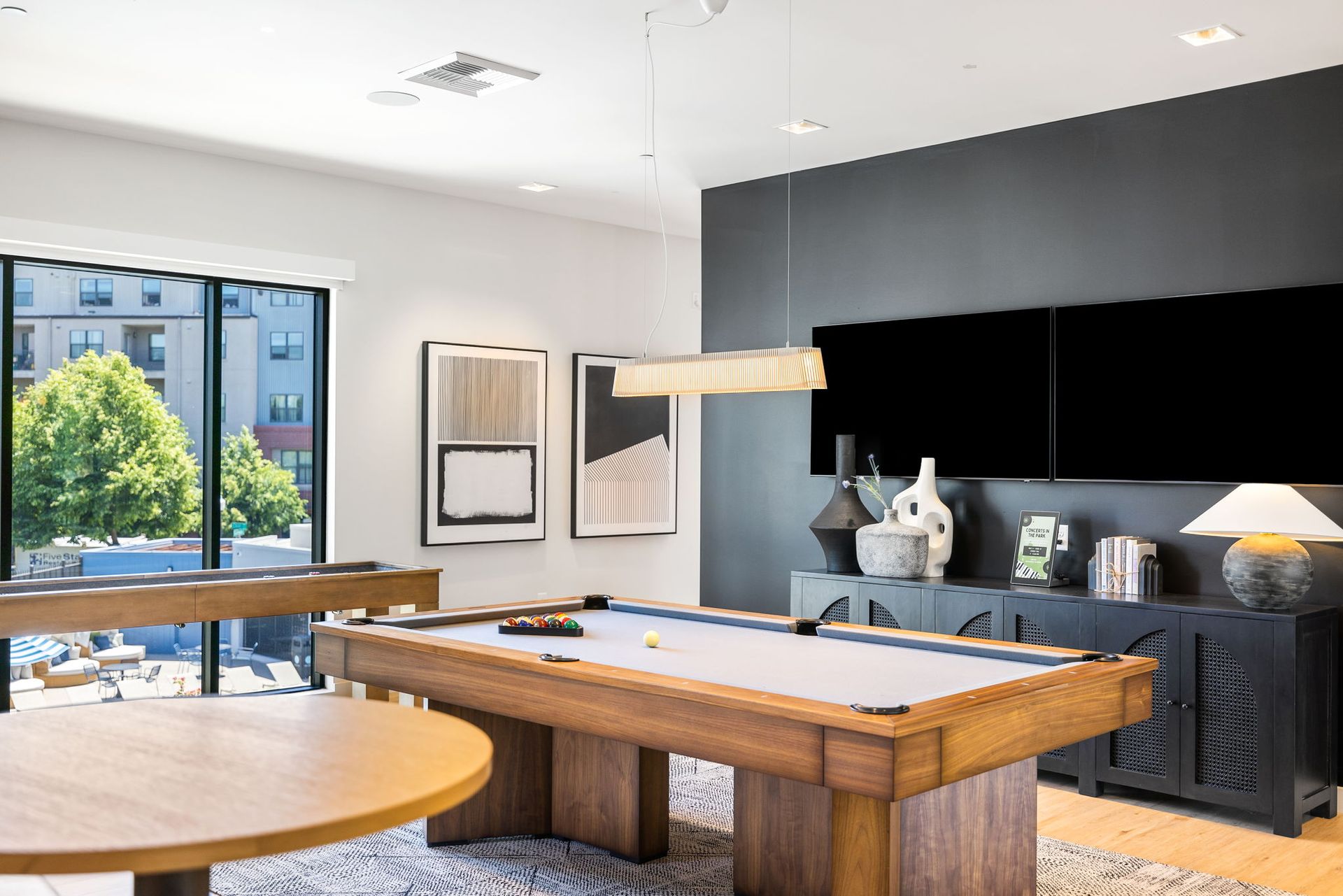 There is a pool table in the middle of the room.