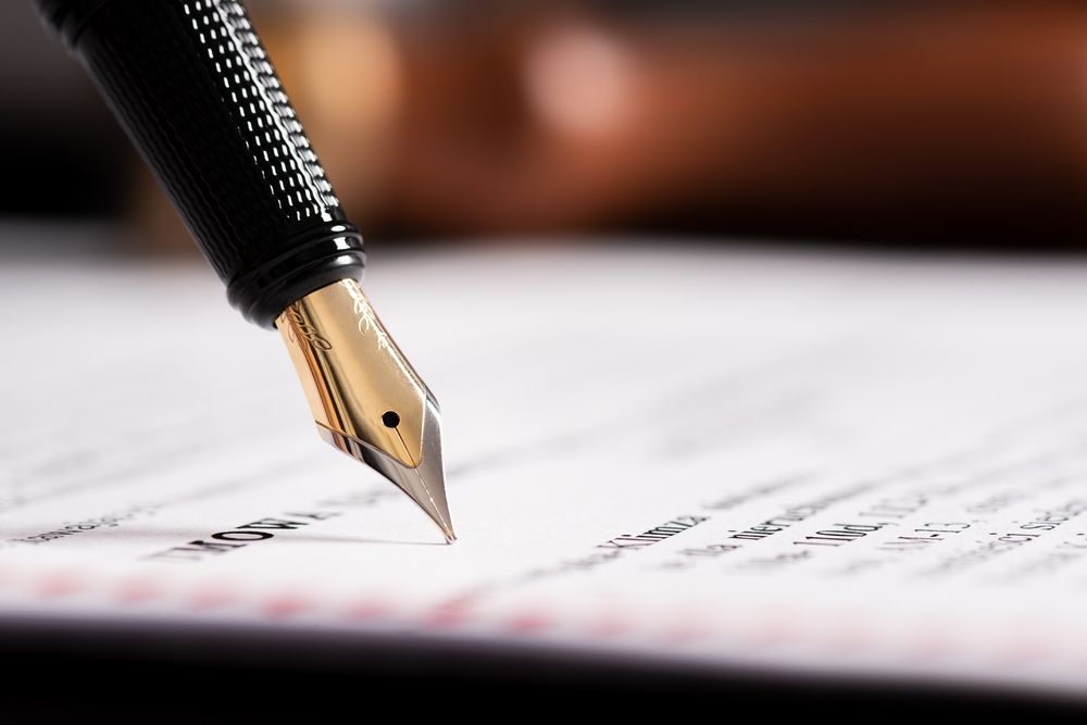 Law, notary background theme. Fountain pen and handmade paper on desk - Lawyer in Woy Woy, NSW