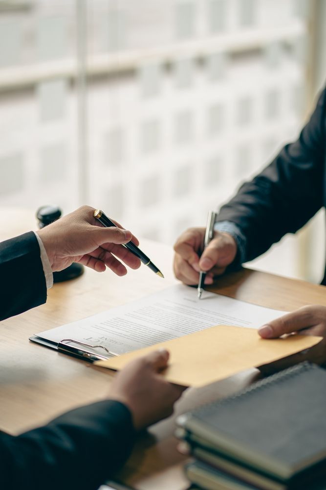 Business people or lawyers discussing contracts or business deals at a law firm - Lawyer in Woy Woy, NSW