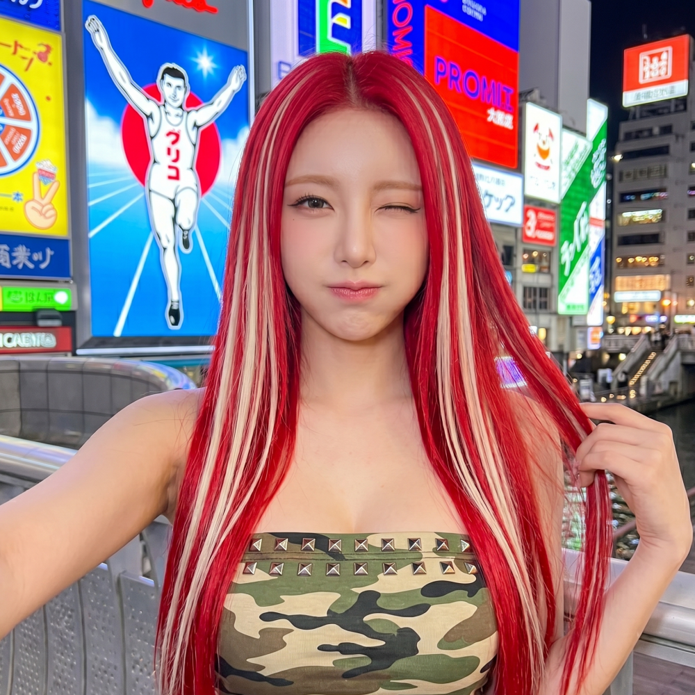 Woman with long red hair winks on a neon-lit city street, wearing a camouflage tube top at busan gwangalli haeundae