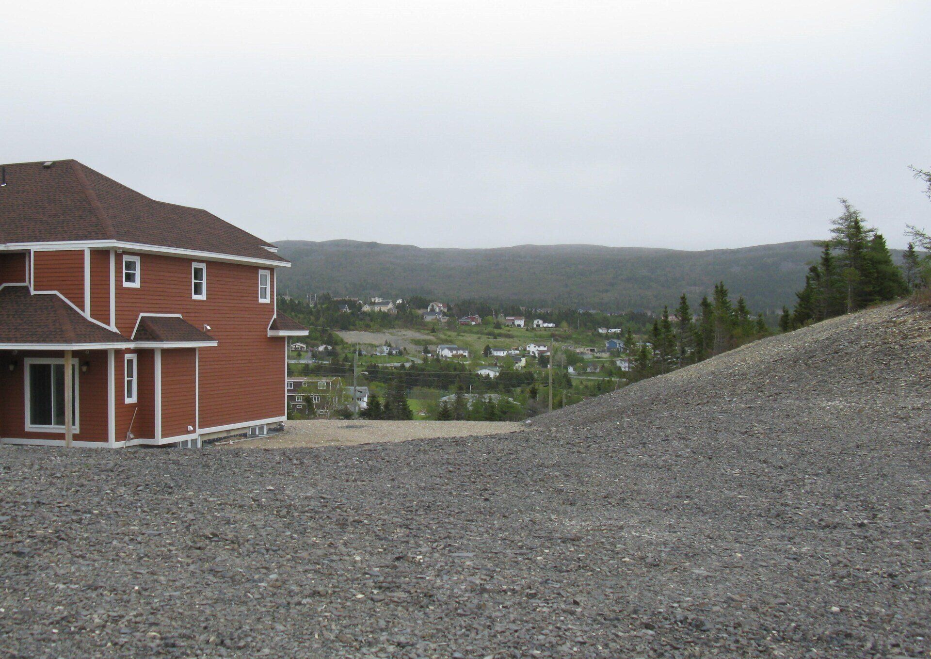 A house with a lot of gravel in front of it