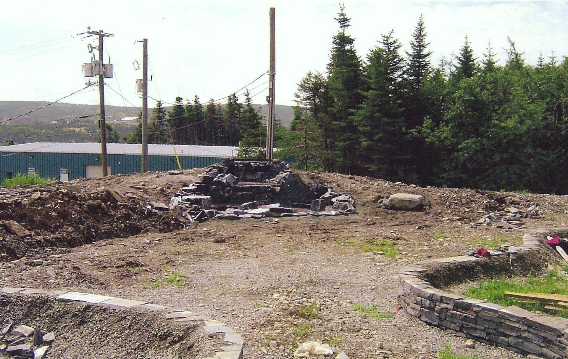 A pile of dirt sits in the middle of a dirt road