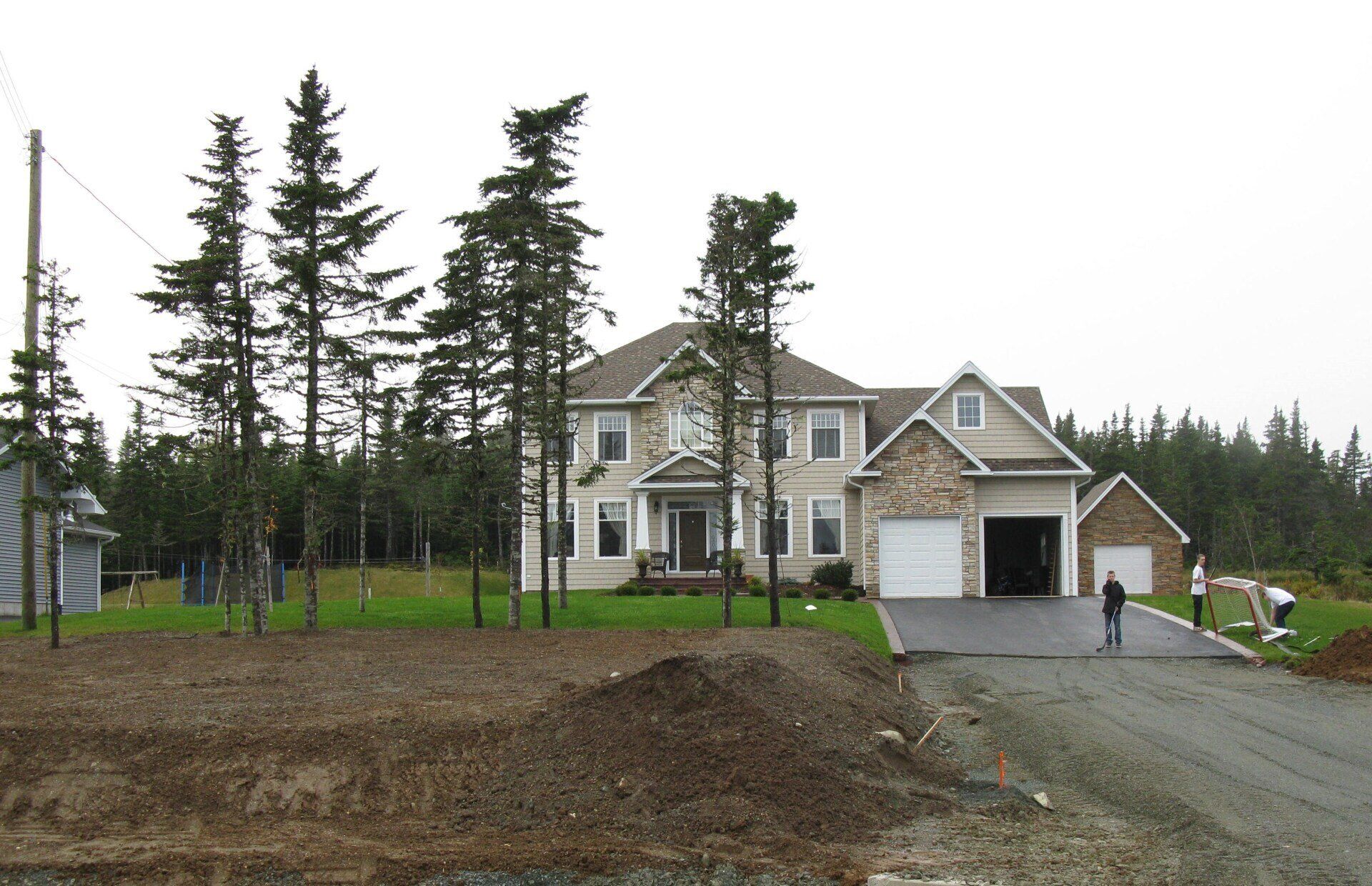 A large house sits in the middle of a forest