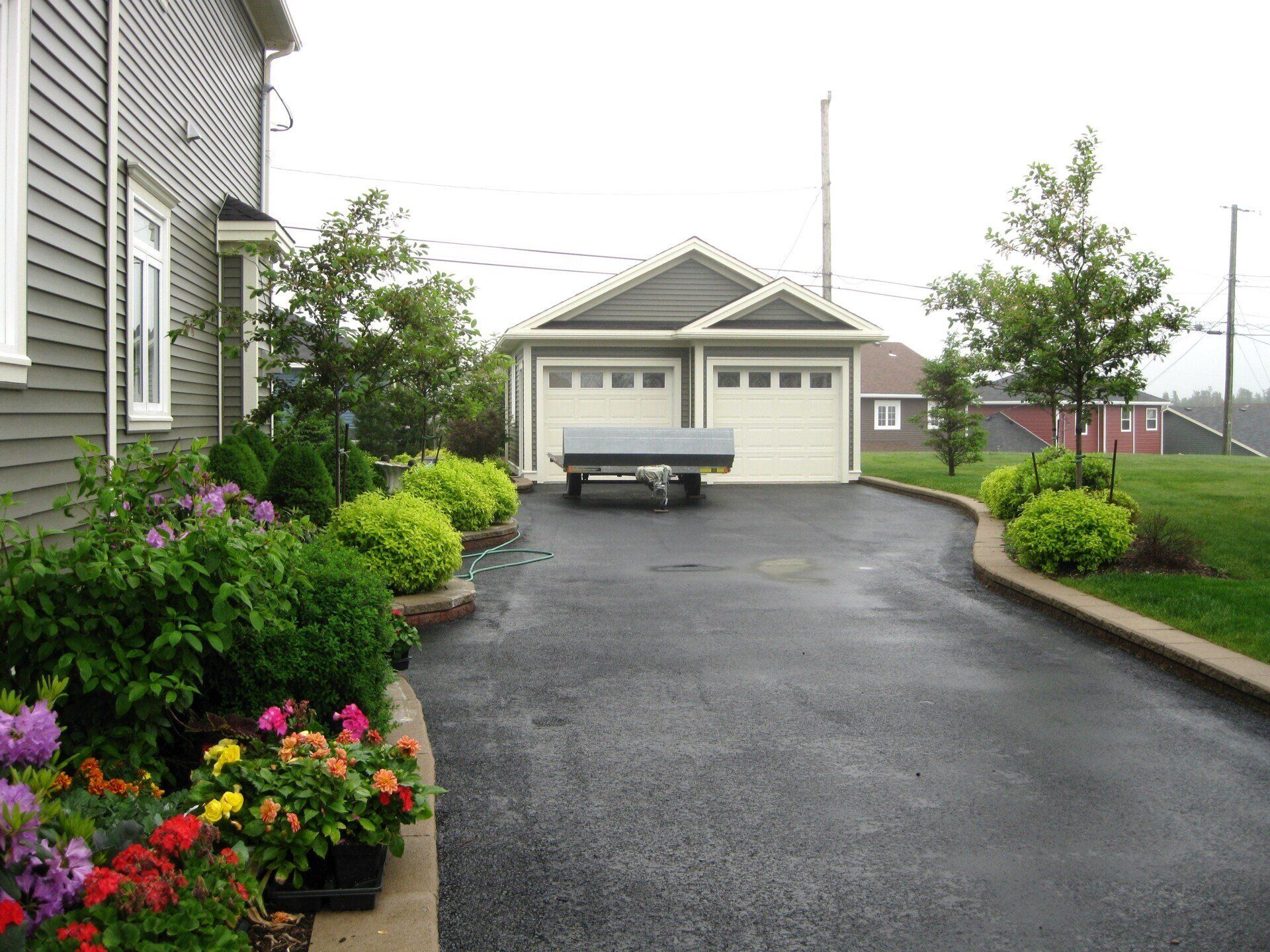 A car is parked in a driveway next to a house