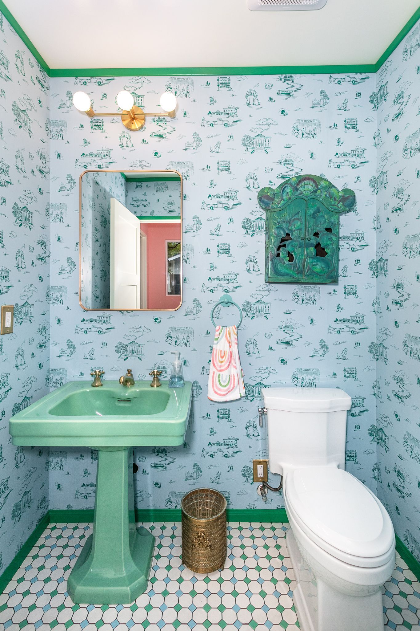 Jack and Jill featuring a tile floor, a refurbished old pedestal sink, and waterproof wallpaper.