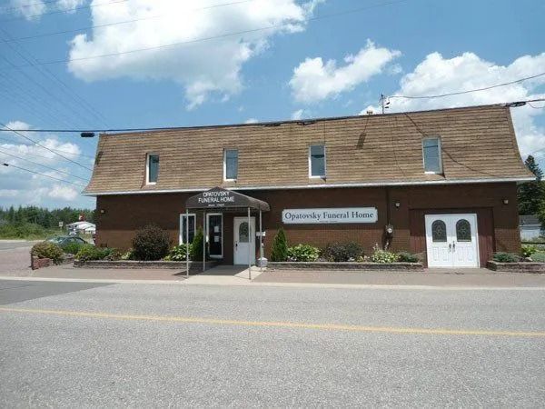 Brick bank building with a sign reading “Conservancy Savings Bank” under a blue sky