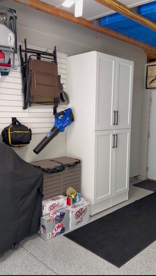 Walk-in closet with light wood cabinets, shelves, and drawers under a ceiling light.