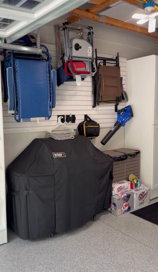 Walk-in closet with light wood cabinets, shelves, and drawers under a ceiling light.
