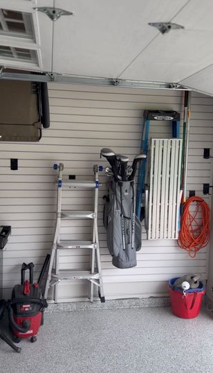 Walk-in closet with light wood cabinets, shelves, and drawers under a ceiling light.