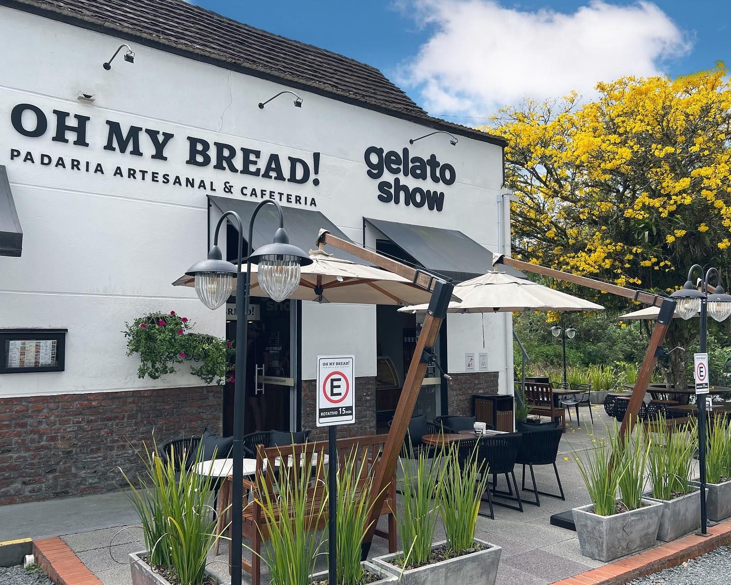 A white building with a sign that says oh my bread
