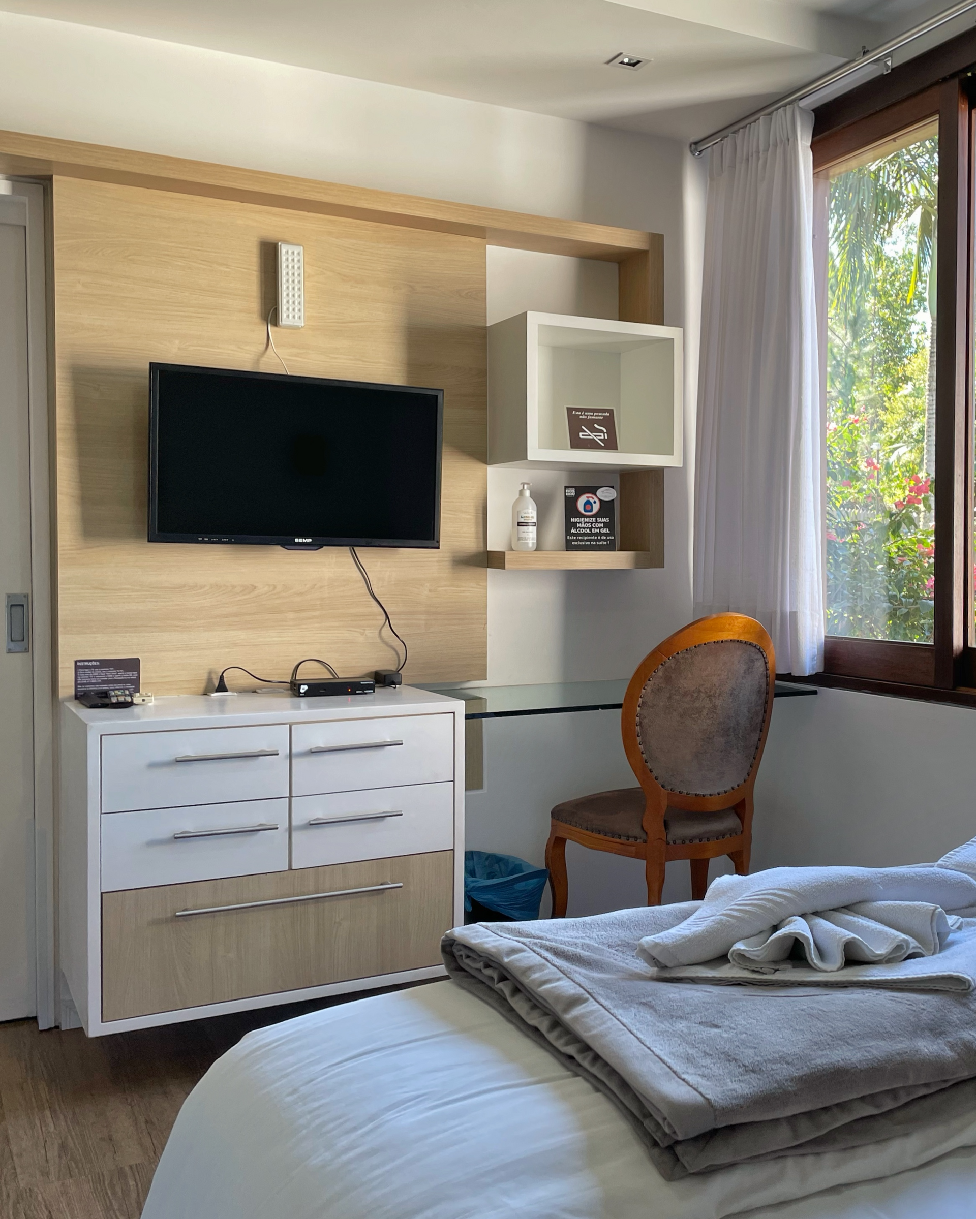 A bedroom with a bed , desk , chair and television.
