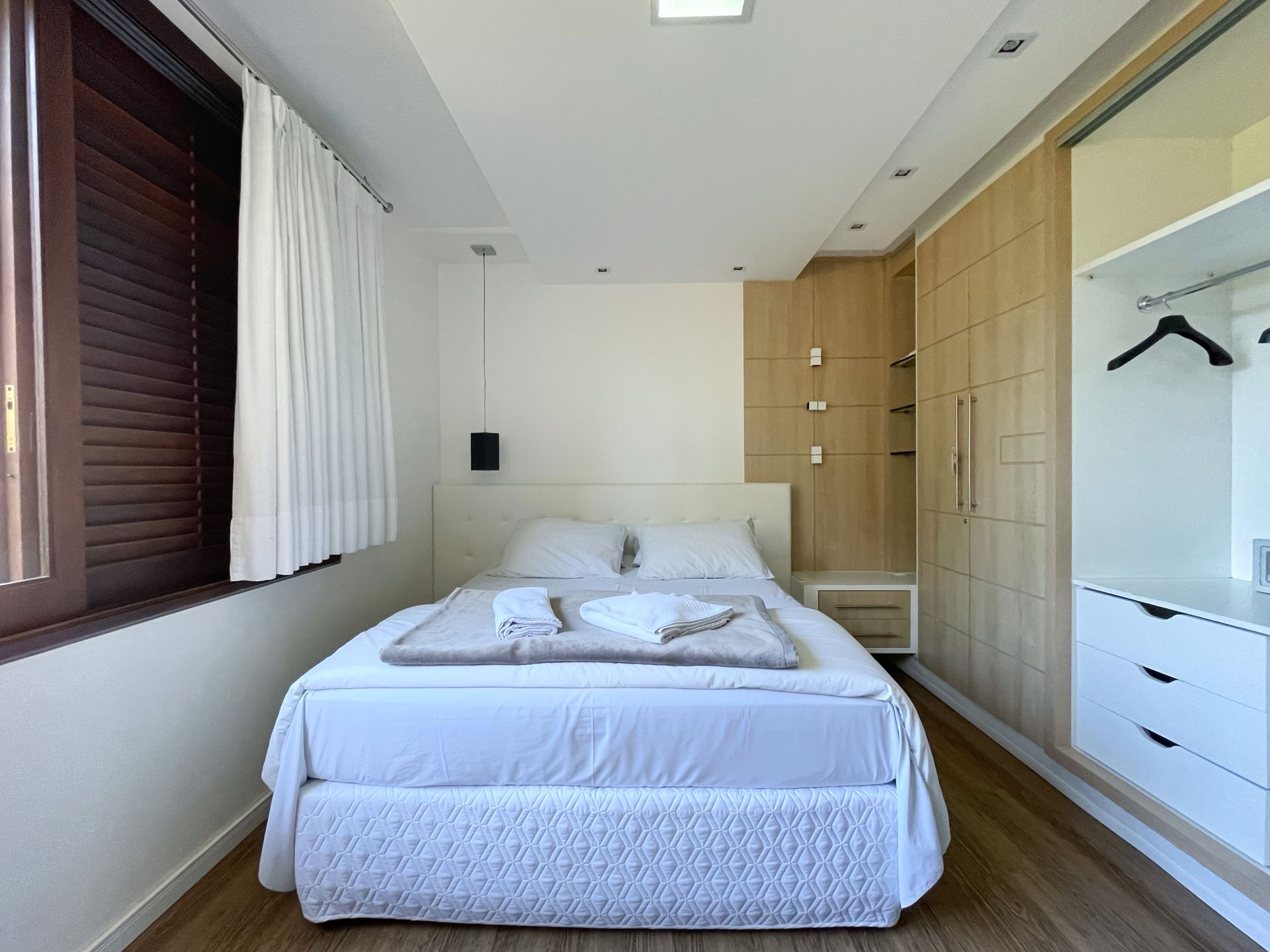 A small bedroom with a bed and a window