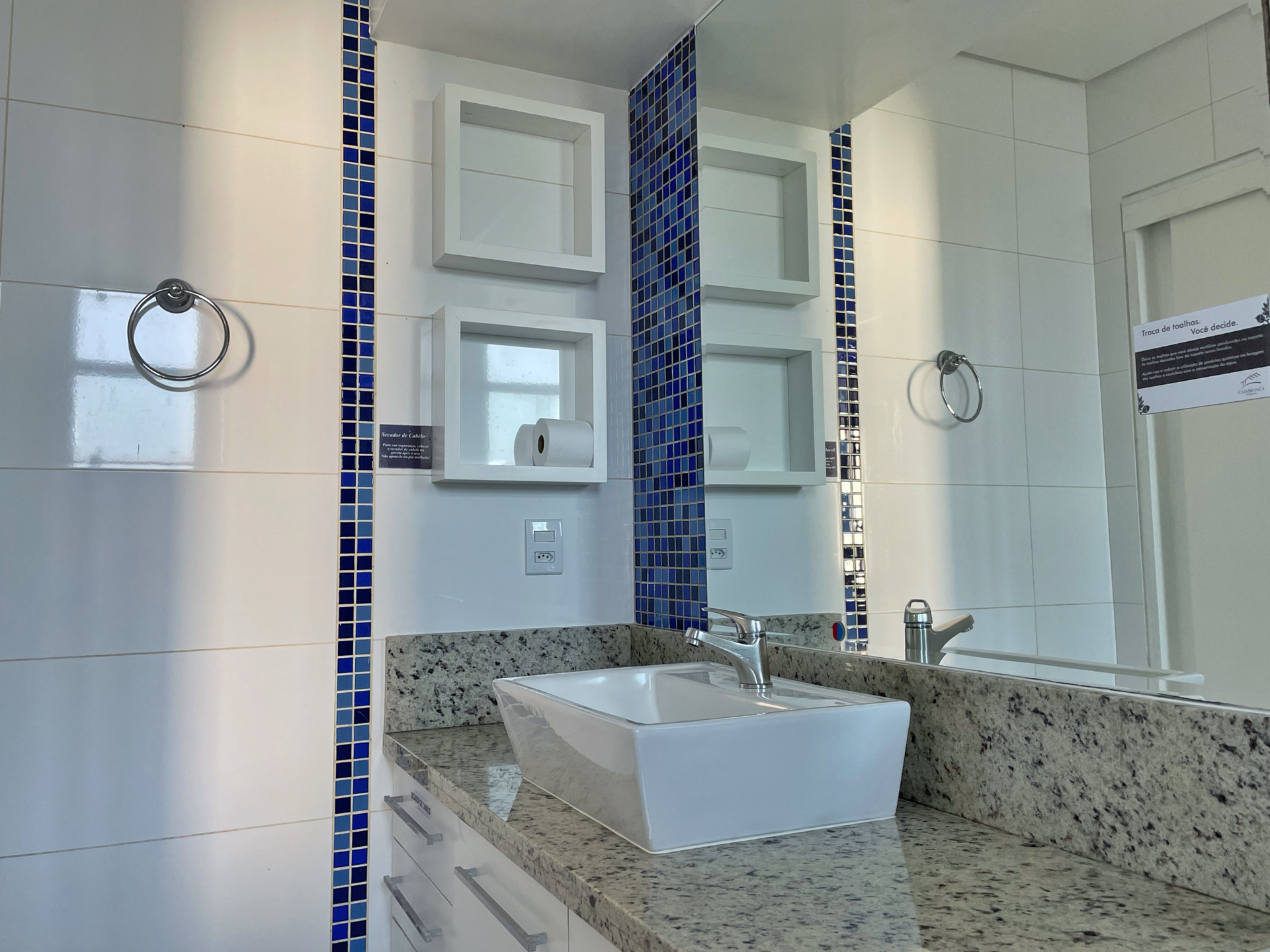 A bathroom with a sink and a large mirror