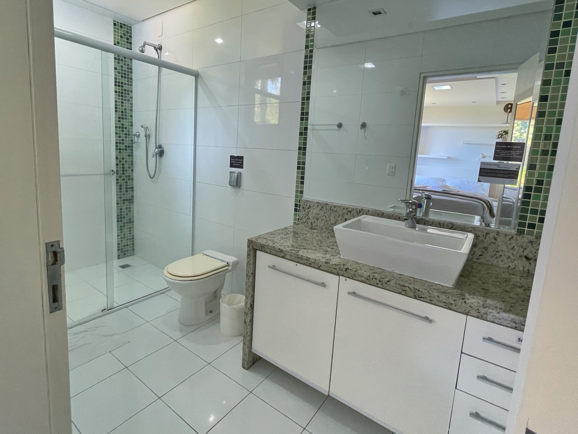 A bathroom with a sink , toilet and shower.