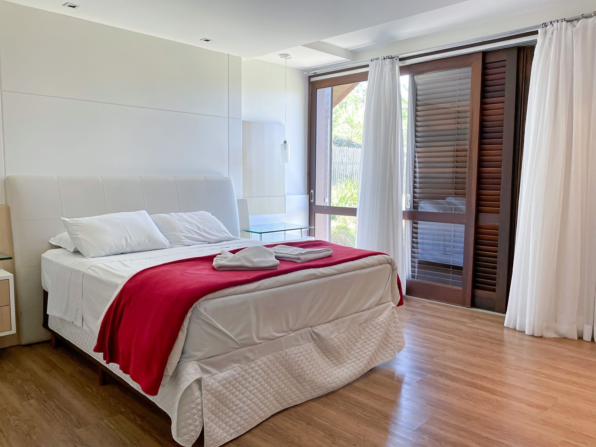 A bedroom with a bed and a sliding glass door