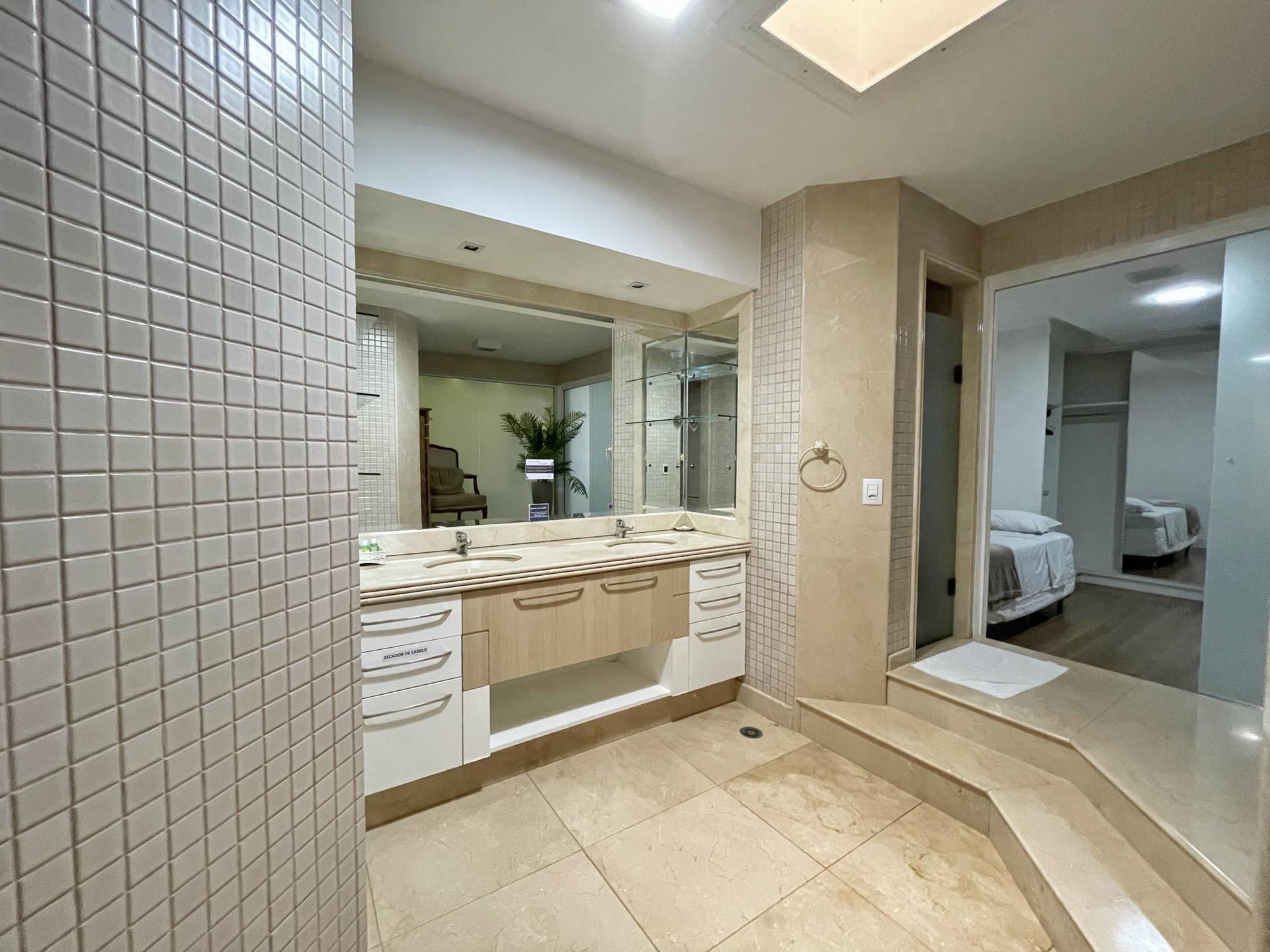 A bathroom with two sinks and a large mirror.