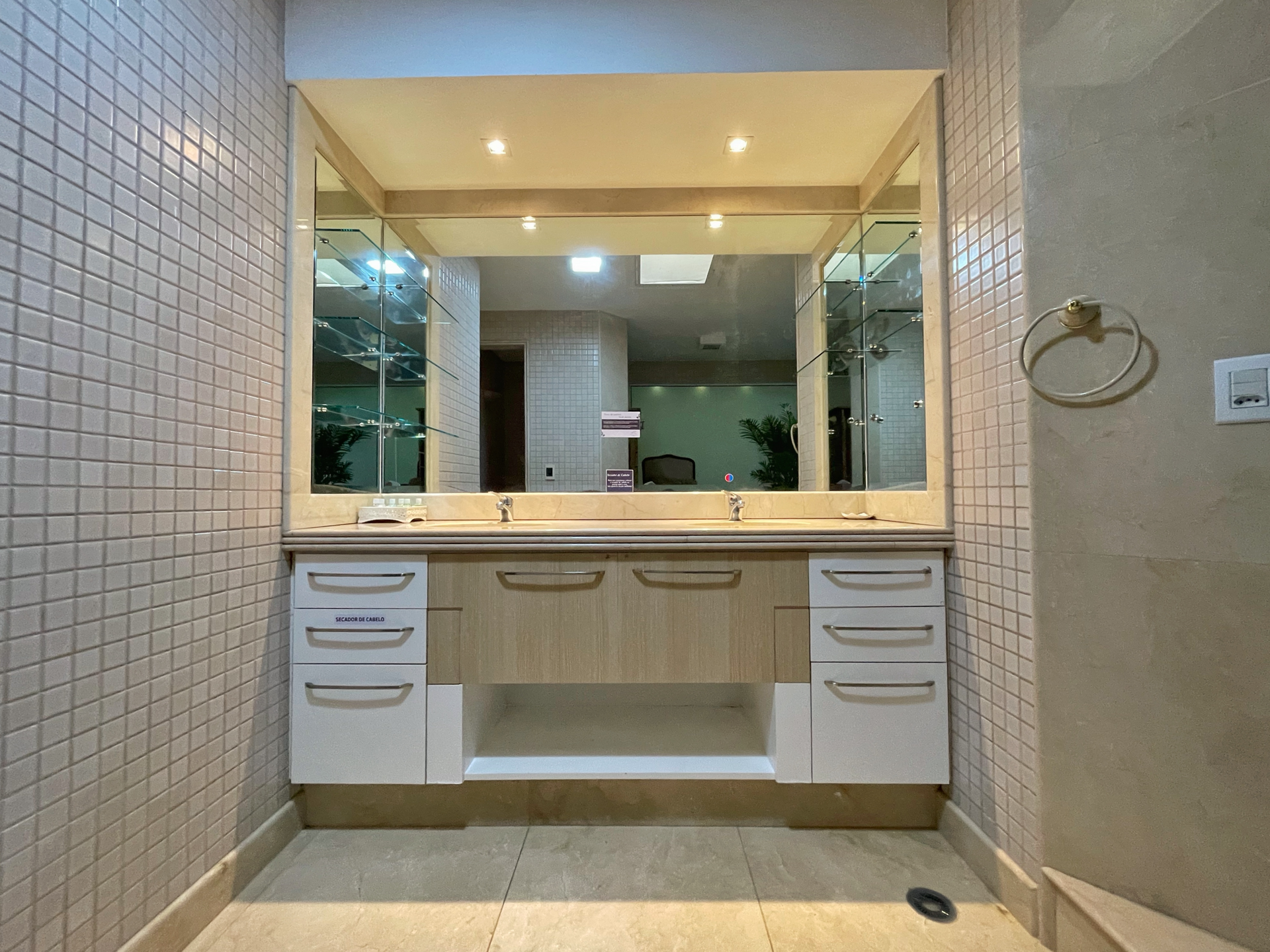 A bathroom with two sinks and a large mirror