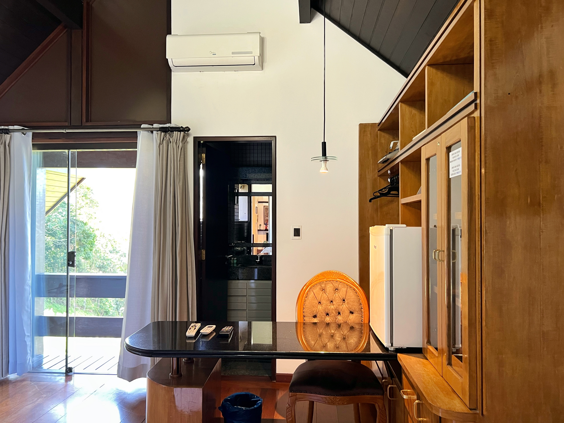 A living room with a table and chairs and a refrigerator