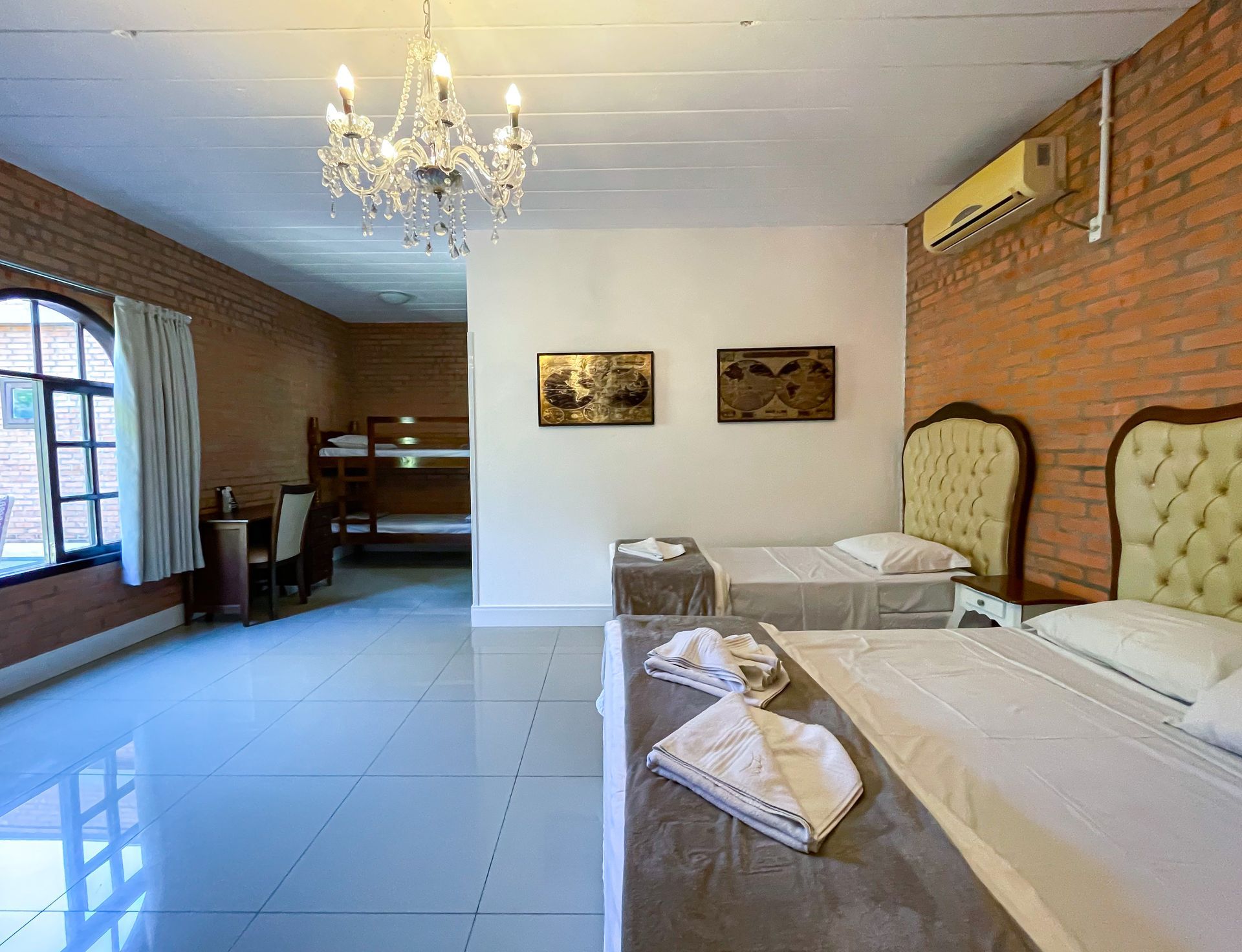 A hotel room with three beds and a bunk bed.