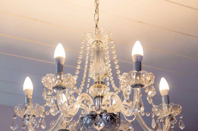 A chandelier with candles hanging from the ceiling