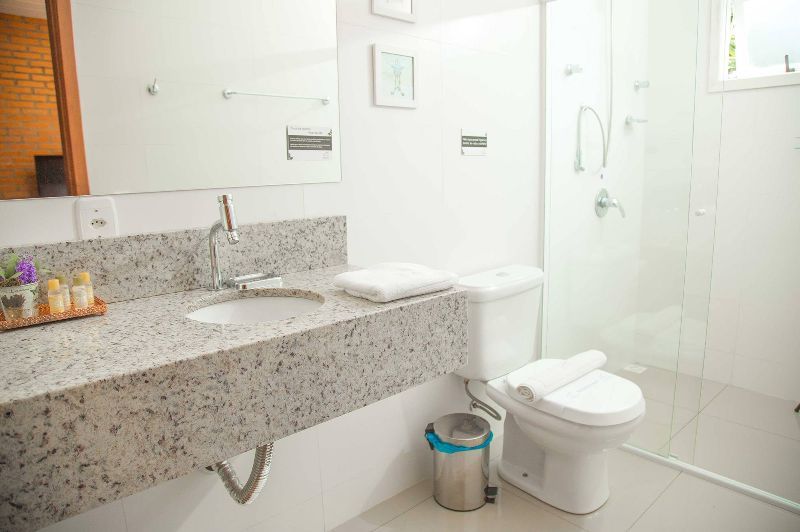 A bathroom with a sink , toilet and shower.