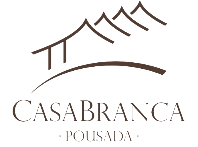 A logo for casa branca pousada with mountains in the background