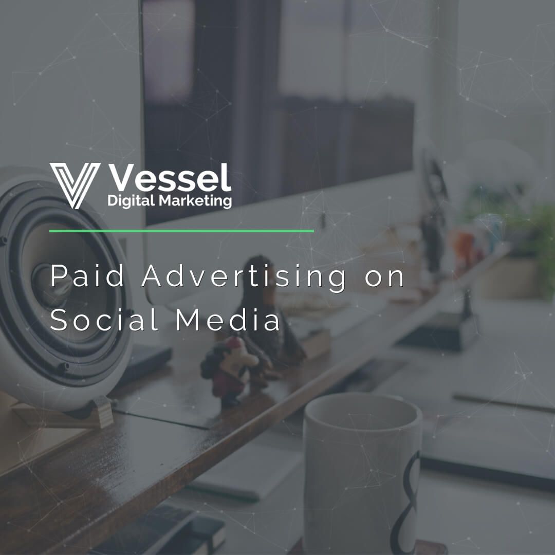 A poster for vessel digital marketing shows a desk with a speaker and a cup on it