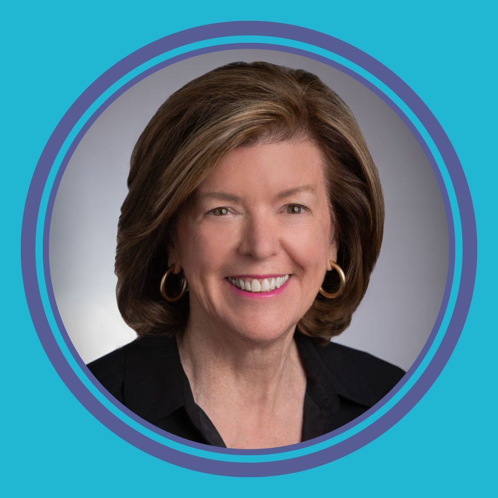 Portrait of a smiling woman with short brown hair on a blue background, framed by a circular border