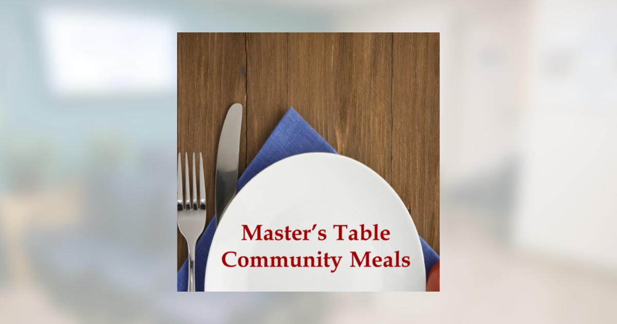 Round table setting with white napkin and blue cloth, labeled “Master’s Table Community Meals.”