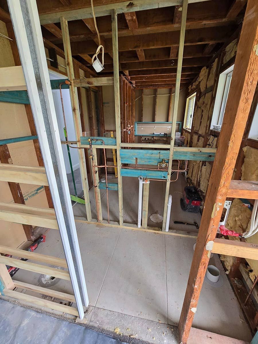 A Room Under Construction With Wooden Beams And A Window — Country 2 Coast Plumbing And Gas In Wauchope, NSW 