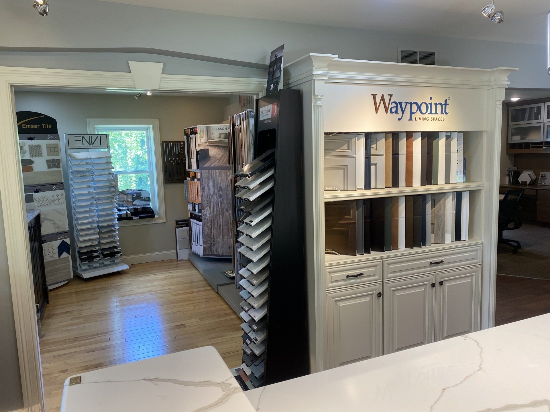 Interior of a Waypoint store display showing cabinetry and flooring samples in a showroom