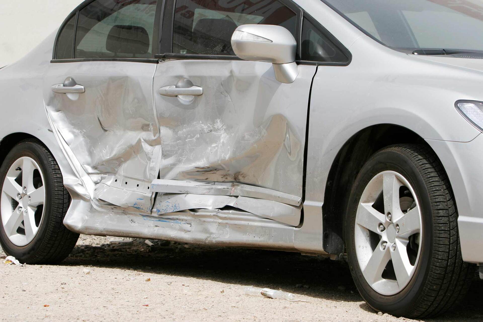 Dented silver car — St. Clairsville, OH — Jeff's Auto Body & Collision Center