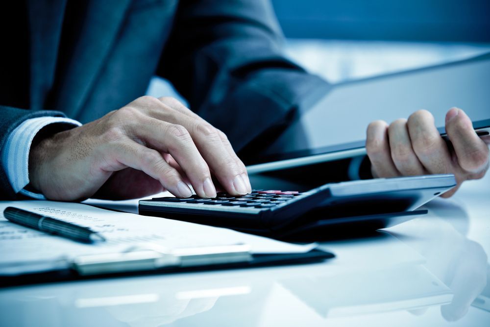 Accountant Using Calculator — Accounting Services in Coffs Harbour, NSW