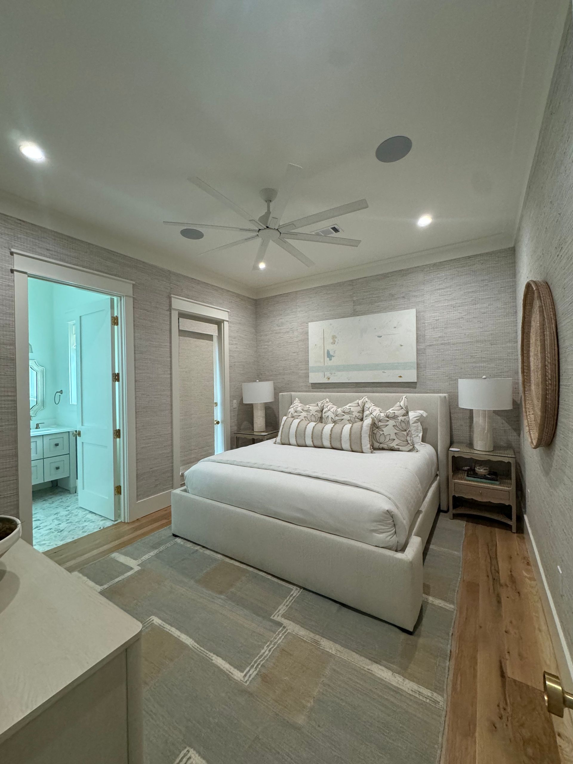 A bathroom with two sinks , a tub , and a large mirror.