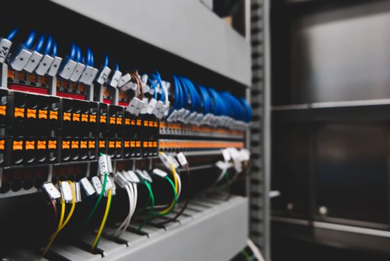 Network server rack with blue cables and labeled ports in a data center rack cabinet