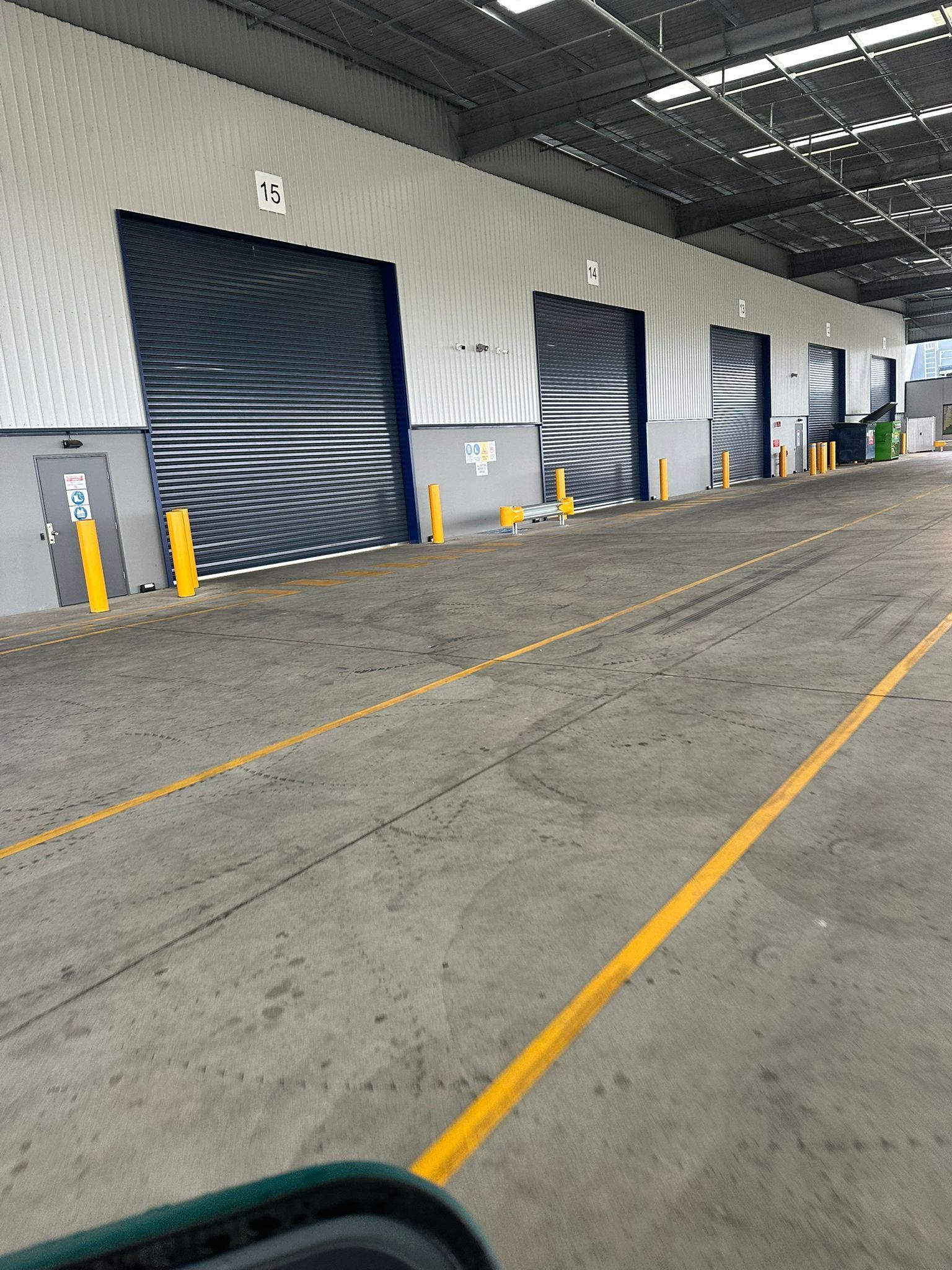 Manufacturing plant interior with floor scrubbing machine