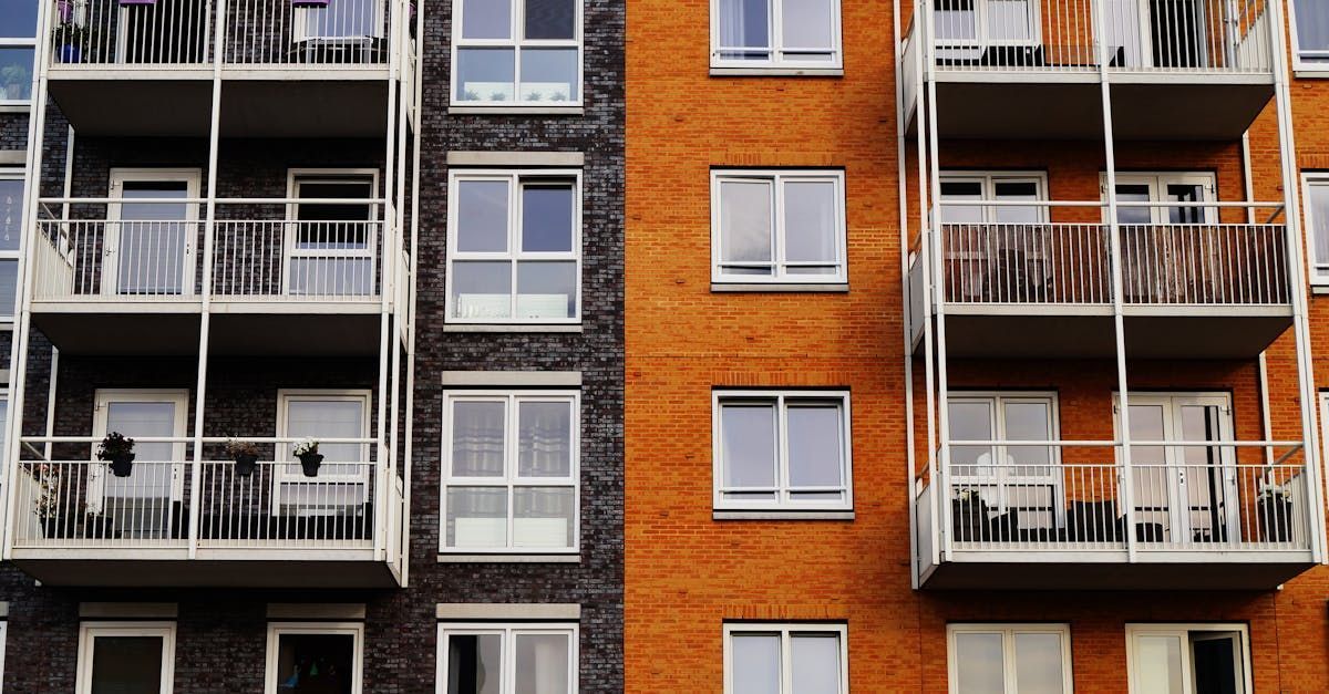 A row of apartment buildings with balconies and windows.