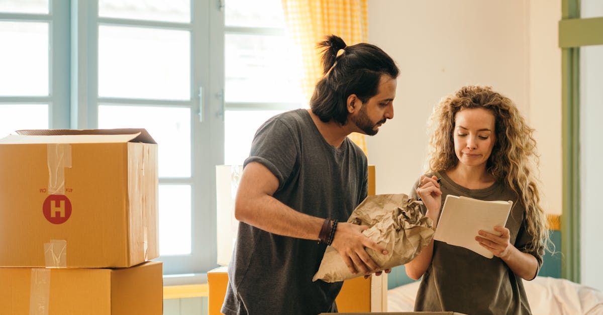 A man and a woman are moving into a new home.